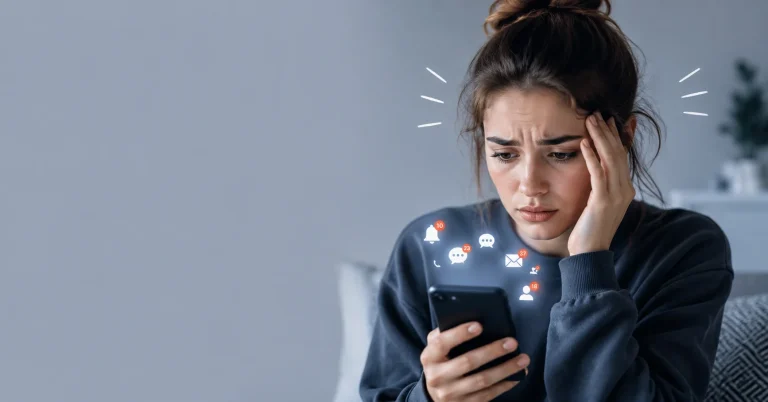 Phone anxiety telephonophobia with a stressed person holding a smartphone and notification icons.